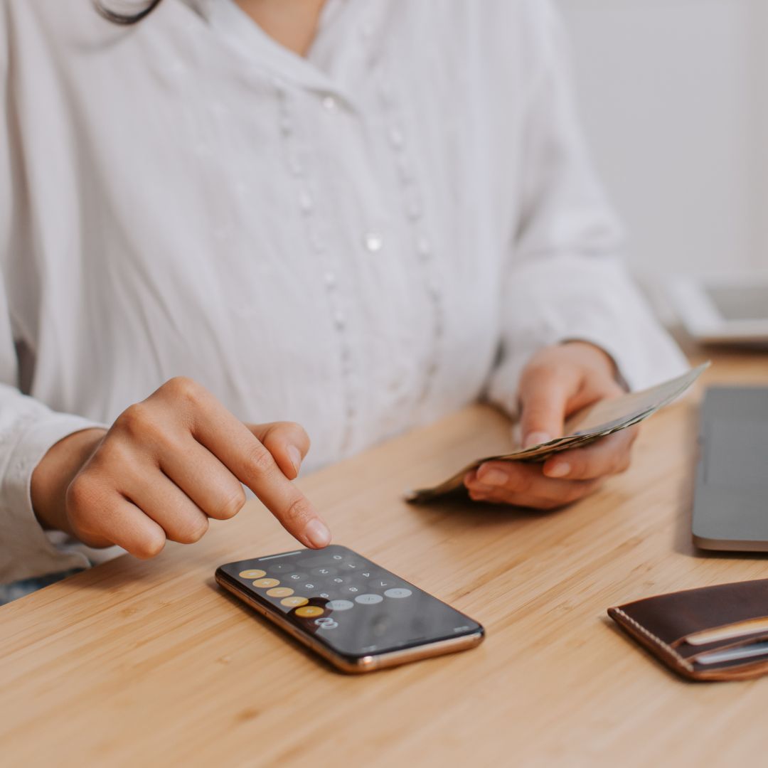 a person planning a budget with a calculator